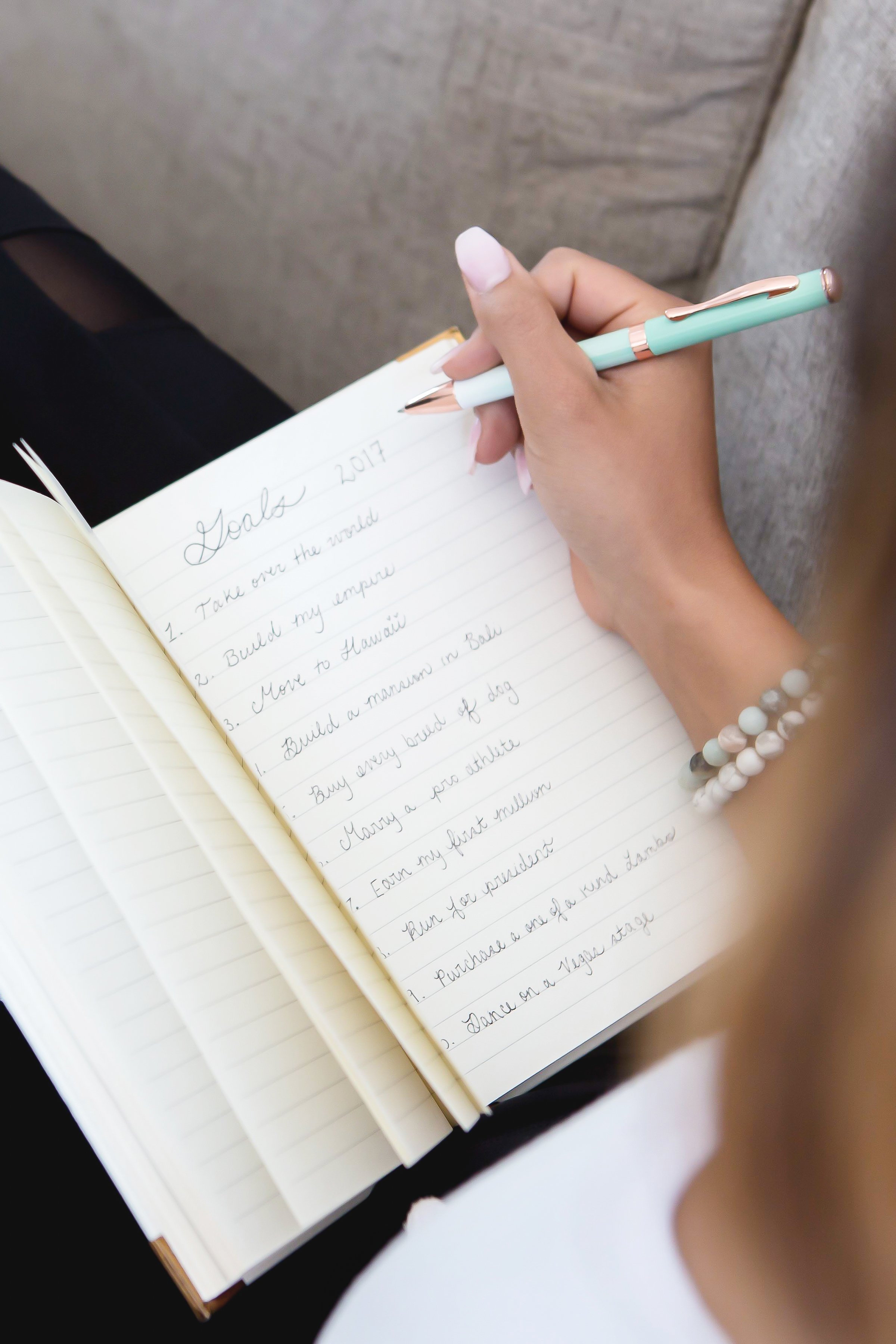 Renee writing out her goals in a notebook